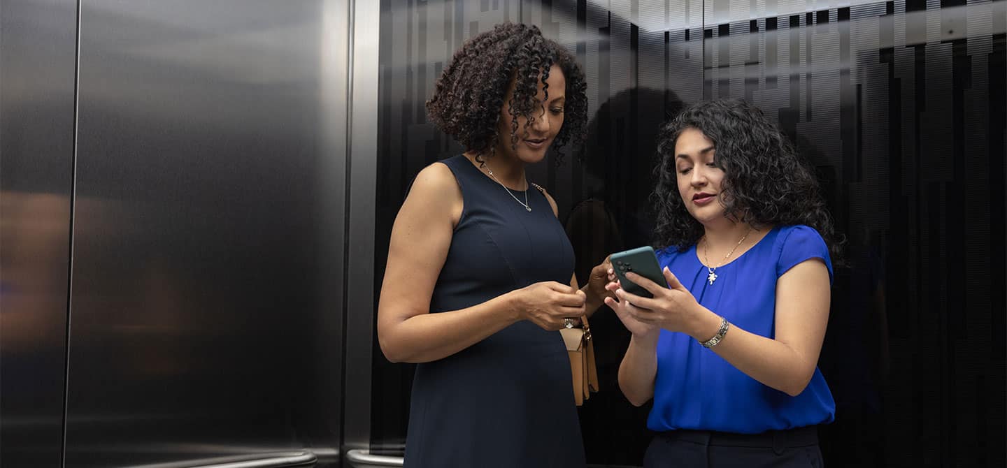 img_ena_women_in_elevator_hero_1440x670